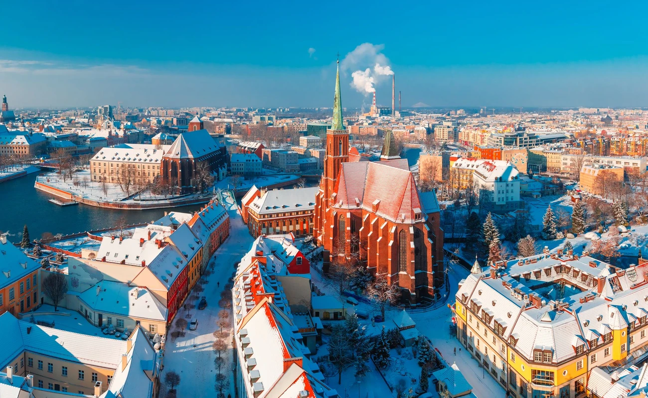Aerial scenic panorama of Old Town and Ostrow Tumski with church of the Holy Cross and St. Bartholomew from Cathedral of St. John in the winter morning in Wroclaw, Poland
