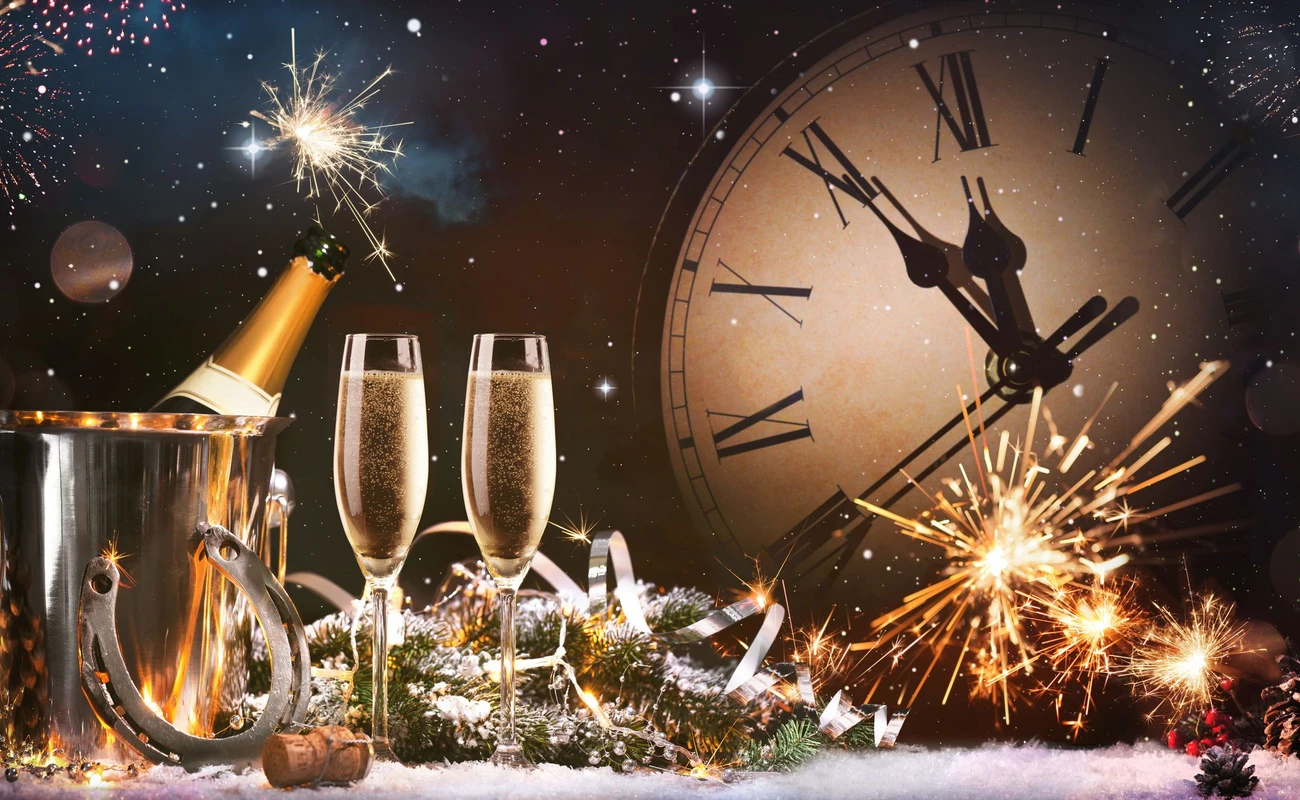 New Years Eve celebration background. Toast with fireworks and champagne at midnight