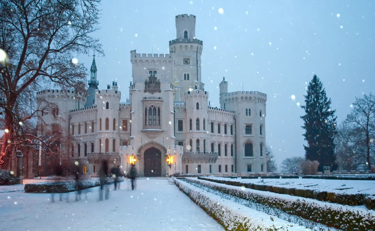 Castle of Hluboka nad Vltavoy at winter. Czech republic. Motion blurred people (tourist)