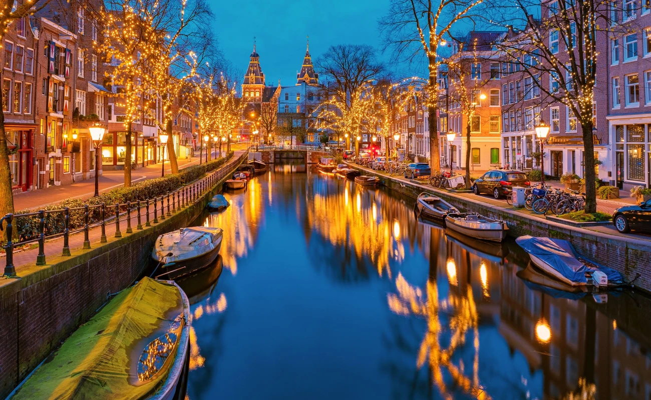 Amsterdam Netherlands canals with Christmas lights during December, canal historical center of Amsterdam at night. Europe