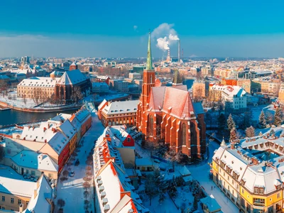 Aerial scenic panorama of Old Town and Ostrow Tumski with church of the Holy Cross and St. Bartholomew from Cathedral of St. John in the winter morning in Wroclaw, Poland