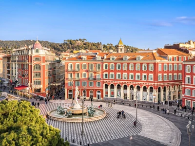 Aerial view of Place Massena square with red buildings  and fountain in Nice, France