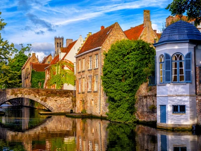 Historical brick houses on a canal in Bruges medieval Old Town, Belgium