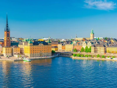 Aerial scenic panoramic view of Stockholm skyline with Old town Gamla Stan, typical Sweden houses, Riddarholmen island with gothic Church building, Lake Malaren, clear blue sky background, Sweden
