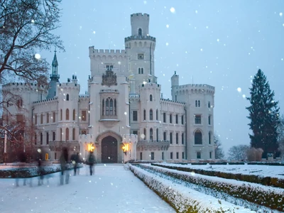 Castle of Hluboka nad Vltavoy at winter. Czech republic. Motion blurred people (tourist)