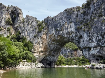 The Pont d'Arc is a natural stone arch in the Ardeche Gorges, France, Europe. Mountain river in European Grand Canyon. Sunny summer day